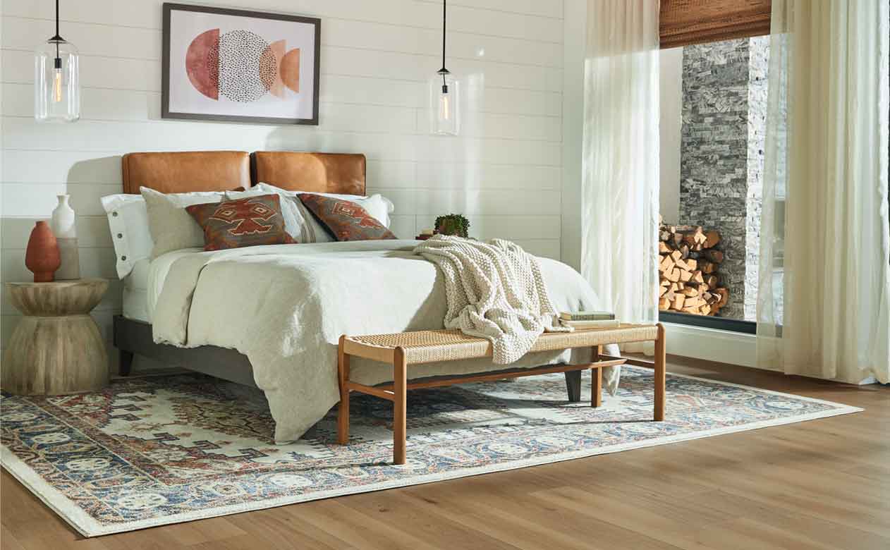 blue and rust colored area rug in bedroom with shiplap walls